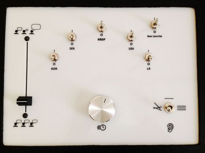 Close-up on the control panel. It's made out of a white, laser-cut acrylic sheet. Acronyms refer to the name of political groups of the french Parliament during the 14th legislature.